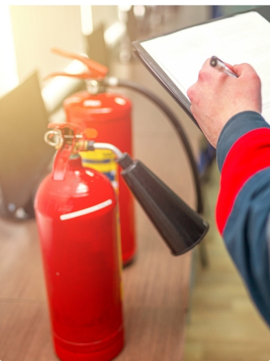 A safety inspector checking fire extinguishers