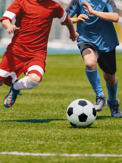 Two people playing football on a 3g pitch