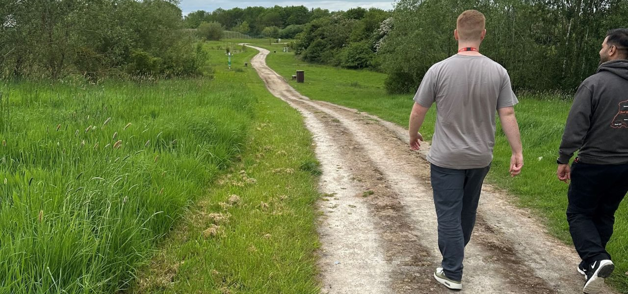 2 men walking down a country lane