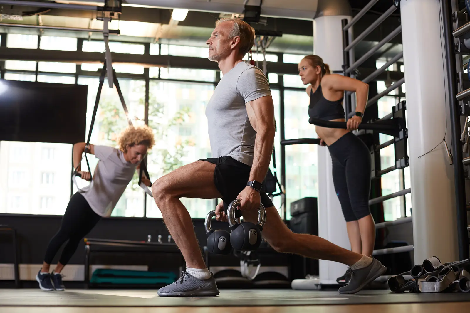 A group of people using different stations in a gym.