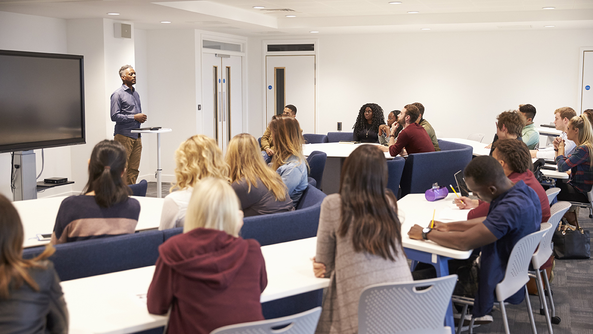 University students study in a classroom with male lecturer